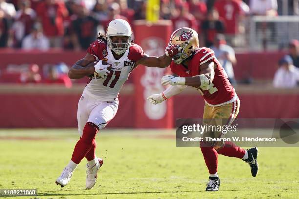 Wide receiver Larry Fitzgerald of the Arizona Cardinals runs with the football after a reception past linebacker Fred Warner of the San Francisco...