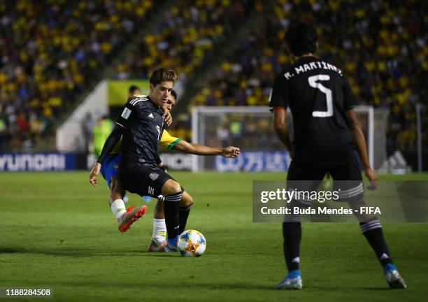 Santiago Munoz of Mexico looks to break past Veron of Brazil during the Final of the FIFA U-17 World Cup Brazil 2019 between Mexico and Brazil at the...