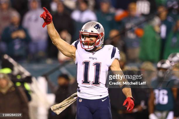 Julian Edelman of the New England Patriots celebrates after throwing a touchdown pass to Phillip Dorsett II during the third quarter against the...