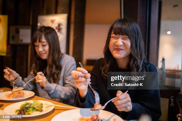 happy young woman eating lunch at cafe - japanese restaurant stock pictures, royalty-free photos & images