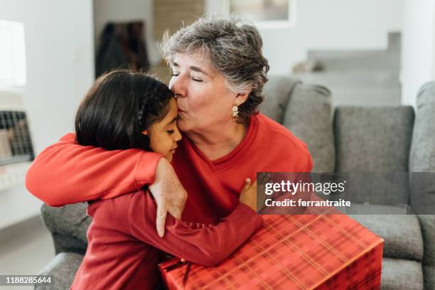 family christmas morning - embracing grandma stock pictures, royalty-free photos & images