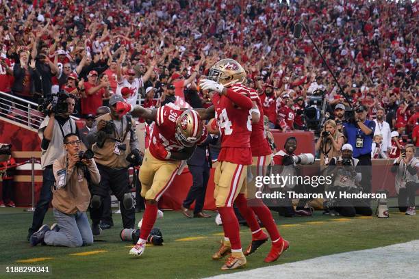 Running back Jeff Wilson Jr. #30 of the San Francisco 49ers celebrates alongside wide receiver Kendrick Bourne after scoring on a 25 yrad touchdown...