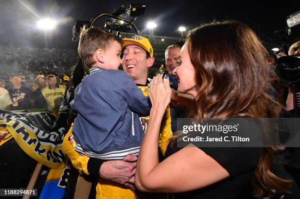 Kyle Busch, driver of the M&M's Toyota, celebrates with his wife, Samantha, and their son, Brexton, after winning the Monster Energy NASCAR Cup...