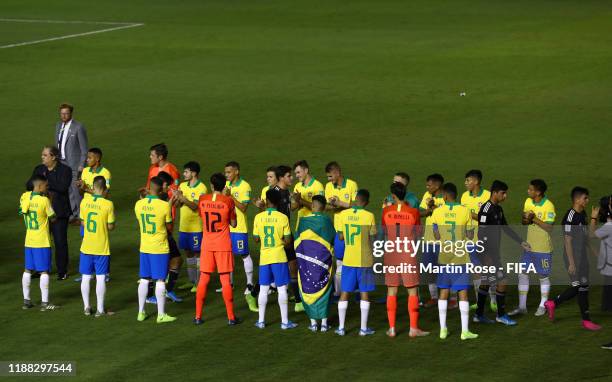 The Brazil side applaud the Mexico side onto the stage during the Final of the FIFA U-17 World Cup Brazil 2019 between Mexico and Brazil at the...