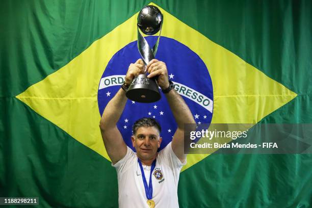 Guilherme Dalla Dea, Coach of Brazil poses for a photo with the trophy during the Final of the FIFA U-17 World Cup Brazil 2019 between Mexico and...