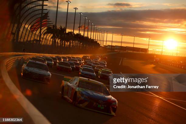 Kyle Busch, driver of the M&M's Toyota, leads a pack of cars during the Monster Energy NASCAR Cup Series Ford EcoBoost 400 at Homestead Speedway on...