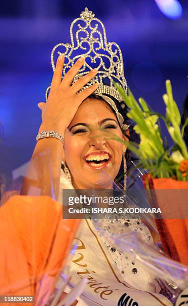 Sri Lankan beauty queen Stephanie Siriwardena reacts as she is crowned Miss Sri Lanka during a glittering contest in Colombo on July 11, 2011. The...
