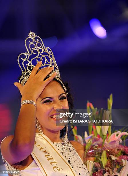 Sri Lankan beauty queen Stephanie Siriwardena waves as she is crowned Miss Sri Lanka during a glittering contest in Colombo on July 11, 2011. The...