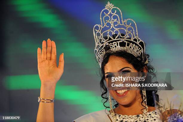 Sri Lankan beauty queen Stephanie Siriwardena waves after being crowned Miss Sri Lanka during a glittering contest in Colombo on July 11, 2011. The...