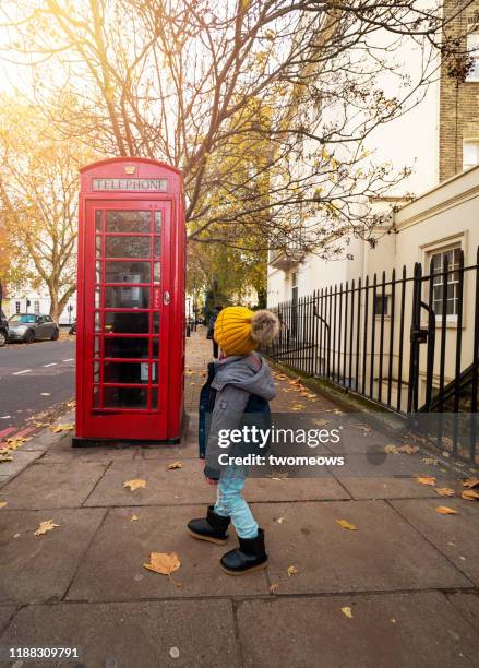 east asian boy in london vacation. - london phone booth stock pictures, royalty-free photos & images