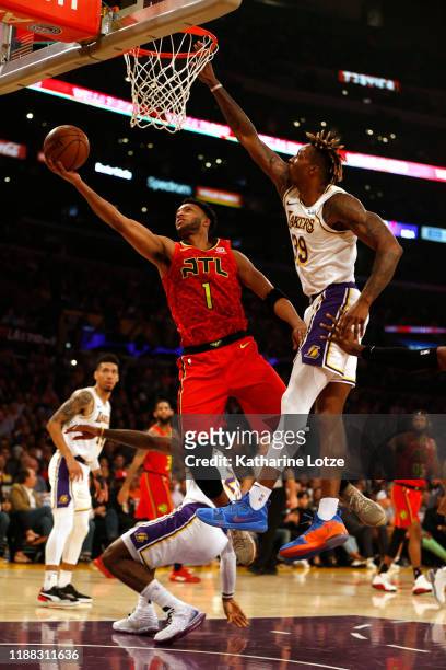 Evan Turner of the Atlanta Hawks goes up for a shot as he's guarded by Dwight Howard of the Los Angeles Lakers during the first half of a game at...