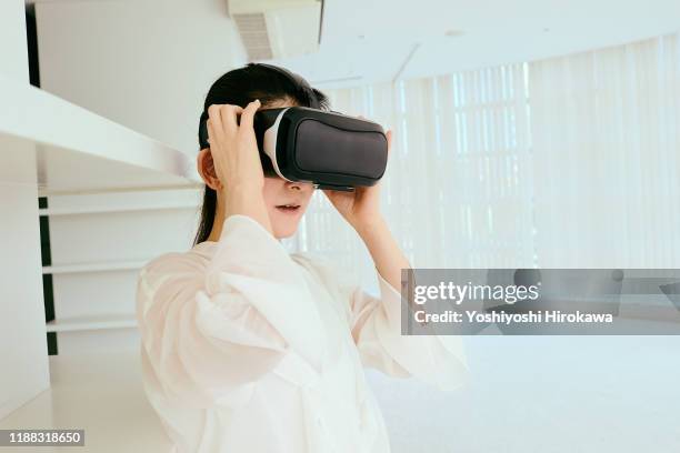 female instructor looks at virtual reality - virtual coach stock pictures, royalty-free photos & images