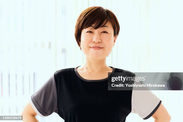 portrait of mature japanese woman in fitness studio - arms akimbo stock pictures, royalty-free photos & images