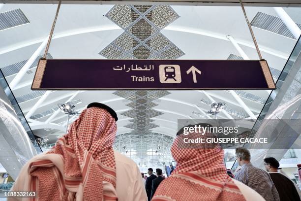 People walk on the platform of the Haramain High Speed Rail Network, Saudi Arabia's two Muslim holy cities of Mecca and Medina, at the airport...