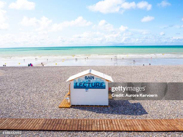 summer time with a "bath of lecture" beach hut in mers-les-bains near le treport in baie de somme in northern france - baie de somme stock pictures, royalty-free photos & images