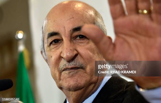 Algerian President-elect Abdelmadjid Tebboune waves to greet attendees during a press conference in the capital Algiers, on December 13, 2019. -...