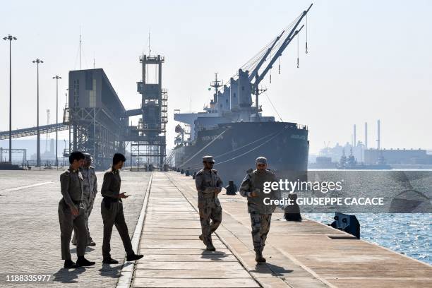 Saudi security forces walk along a pier at the docks of Ras al-Khair port, about 185 kilometres north of Dammam in Saudi Arabia's eastern province...