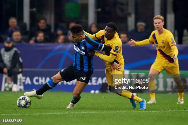 Lautaro Martinez of Inter of Milan and Moussa Wague of Barcelona battle for the ball during the UEFA Champions League group F match between Inter and...