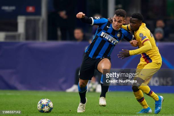 Lautaro Martinez of Inter of Milan and Moussa Wague of Barcelona battle for the ball during the UEFA Champions League group F match between Inter and...
