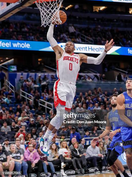 Russell Westbrook of the Houston Rockets goes up for a dunk Michael Carter-Williams and Aaron Gordon of the Orlando Magic during the game at the...