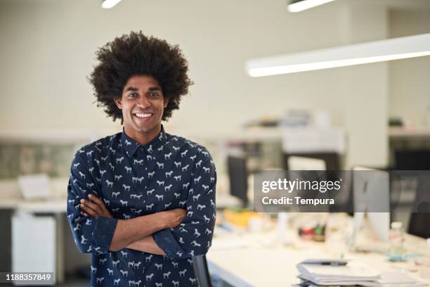 young african american creative looking at camera with arms crossed. - guy with afro stock pictures, royalty-free photos & images