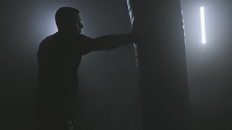 https://media.gettyimages.com/id/1188376643/video/boxer-training-in-low-light-gym-silhouette-of-man-hitting-punching-bag.jpg?b=1&s=640x640&k=20&c=yD2WPDGqYLvZu_lHPzvhV_Jy0ul0bIz8zzbs0LTlkZE=