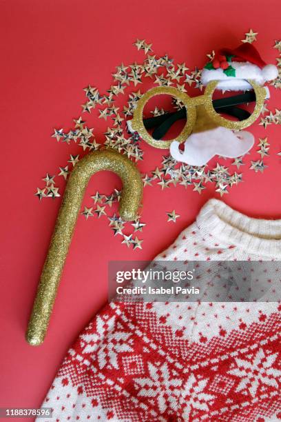 christmas sweater and details on red background - ugly wallpaper stock pictures, royalty-free photos & images