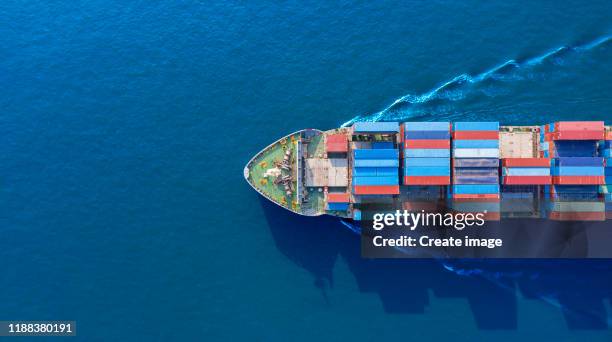 aerial top view container cargo ship full speed with beautiful wave pattern on blue sea for business logistics, import export, shipping or transportation. - industrial sailing craft stock pictures, royalty-free photos & images