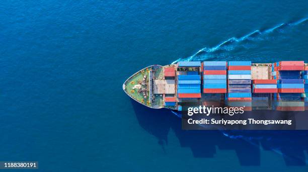 aerial top view container cargo ship full speed with beautiful wave pattern on blue sea for business logistics, import export, shipping or transportation. - industrial sailing craft stock pictures, royalty-free photos & images