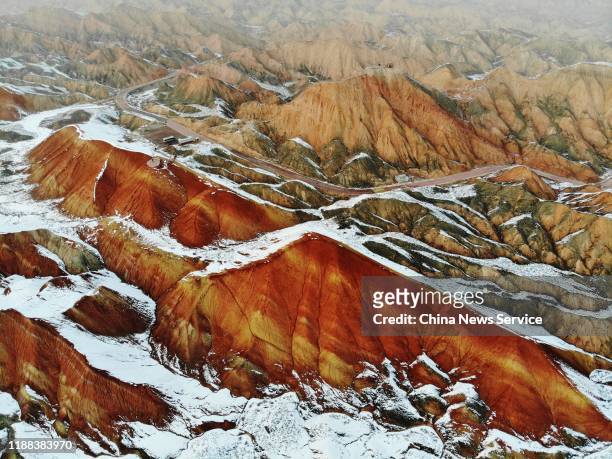View of snow-covered Danxia landform at the Qicai Danxian scenic area on November 17, 2019 in Zhangye, Gansu Province of China. Danxia is a special...