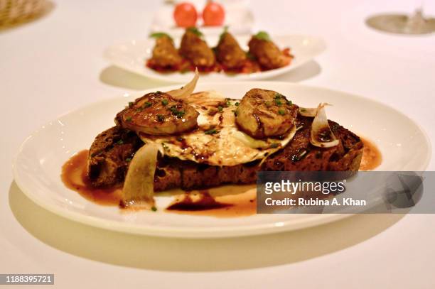 Fried Organic Eggs with Foie Gras and Truffle Sauce at Izu, the Mediterranean cuisine restaurant named after its Nigerian chef, Izu Ani, at the...
