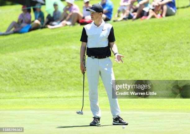 Marcus Kinhult of Sweden askes his playing partners regard a ruling to a ball decision on the fourth green during the final round of the Nedbank Golf...