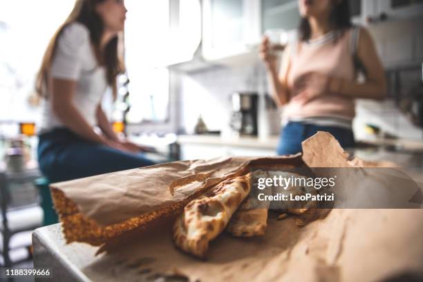 woman eating empanada at home - argentina traditional food stock pictures, royalty-free photos & images