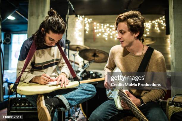 young rock band writing music together - melody maker fotografías e imágenes de stock