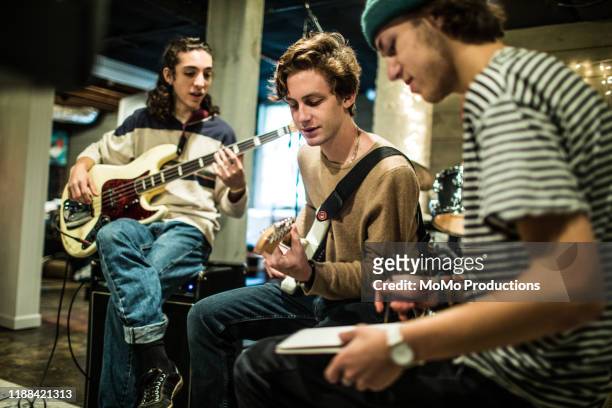 young rock band writing music together - melody maker fotografías e imágenes de stock