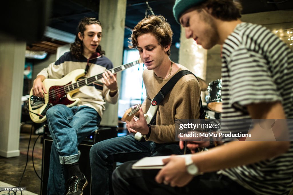 Young rock band writing music together