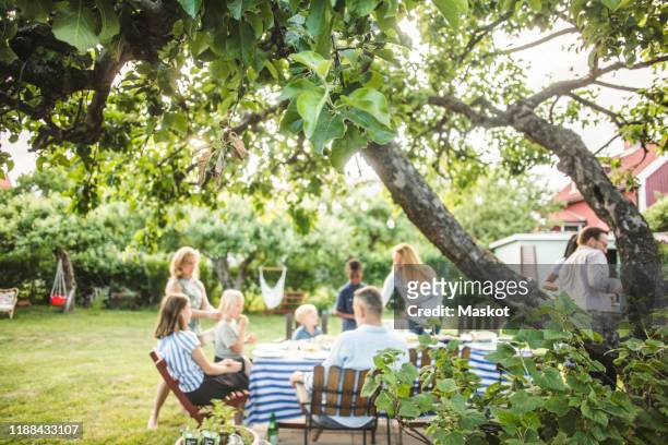 friends and family enjoying at garden party in backyard during weekend - kids background stock pictures, royalty-free photos & images
