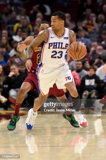 Trey Burke of the Philadelphia 76ers looks for a pass while under pressure from Brandon Knight of the Cleveland Cavaliers during the first half at...