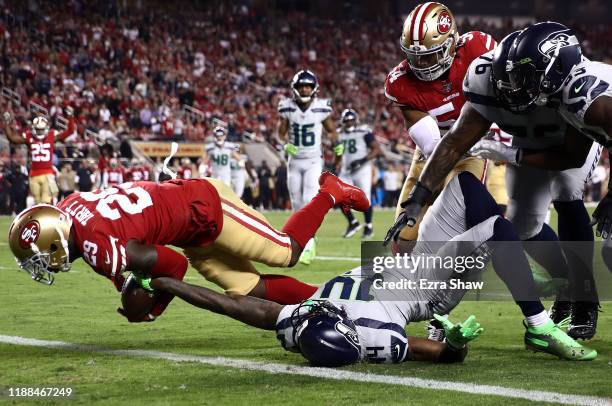 Strong safety Jaquiski Tartt of the San Francisco 49ers strips the ball from wide receiver D.K. Metcalf of the Seattle Seahawks at the two yard line...