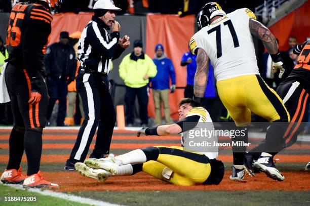 Quarterback Mason Rudolph of the Pittsburgh Steelers sits on the field after fighting with defensive end Myles Garrett of the Cleveland Browns during...