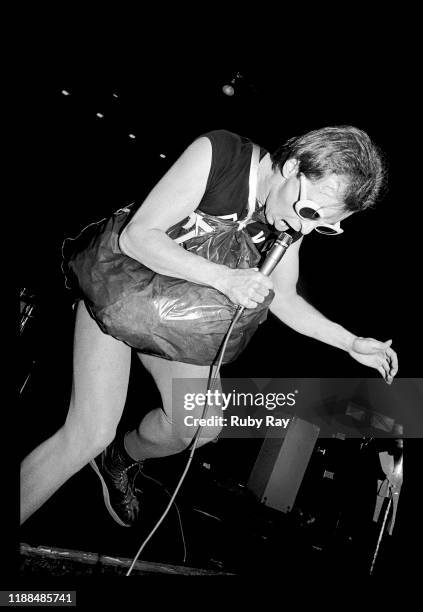 American musician, composer Jerry Casale of rock band DEVO wearing a garbage bag filled with garbage onstage, 1977.