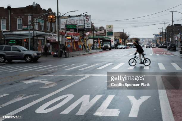 Resident rides their bike in the Brownsville neighborhood of Brooklyn on November 18, 2019 in New York City. As former New York City Mayor Michael...
