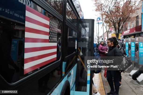 People get on a bus in the Brownsville neighborhood of Brooklyn on November 18, 2019 in New York City. As former New York City Mayor Michael...