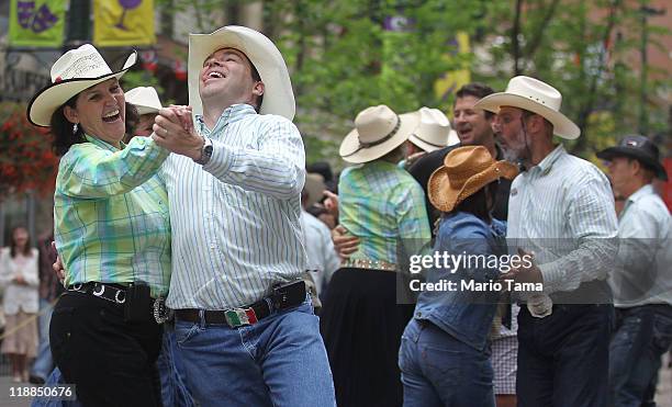 Revelers square dance during the Calgary Stampede on July 11, 2011 in Calgary, Alberta, Canada. The ten day event, drawing over one million visitors,...