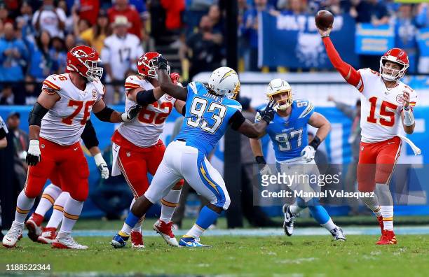 Quarterback Patrick Mahomes of the Kansas City Chiefs delivers a pass over defensive tackle Justin Jones of the Los Angeles Chargers during the game...