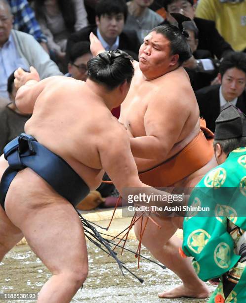 Sekiwake Mitakeumi pushes Mongolian wrestler Tamawashi out of the ring to win on day nine of the Grand Sumo Kyushu Tournament at the Fukuoka...