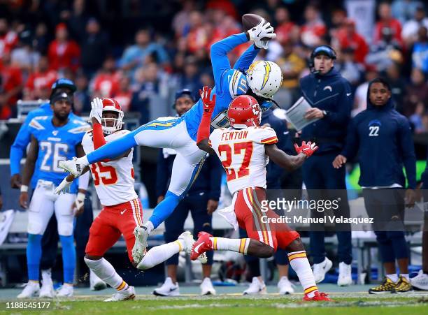 Wide receiver Mike Williams of the Los Angeles Chargers completes a pass over the defense of defensive back Rashad Fenton of the Kansas City Chiefs...