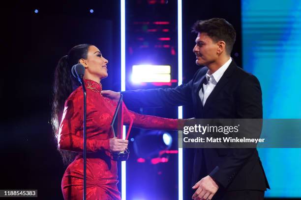 Kim Kardashian presents Mario Dedivanovic with award onstage during the 2nd Annual American Influencer Awards at Dolby Theatre on November 18, 2019...