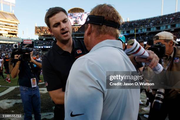 Head coach Jon Gruden of the Oakland Raiders shakes hands with head coach Zac Taylor of the Cincinnati Bengals after the game at RingCentral Coliseum...