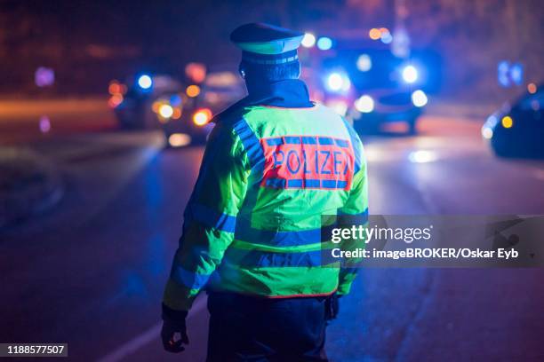 police officer regulates traffic in a traffic accident, stuttgart, germany - polizei stock-fotos und bilder